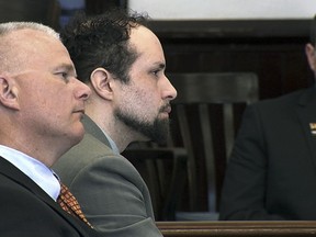 In this still image from video, Luc Tieman, center, and his lawyer Stephen Smith, left, listen inside a courtroom where Tieman was sentenced to 55 years, Friday, May 11, 2018, in Somerset County Superior Court in Skowhegan, Maine. Tieman, who was convicted in April of killing his wife, did not address the court.