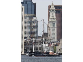 The USS Constitution glides through Boston Harbor past the city skyline on a cruise to honor Vietnam veterans, Friday, May 18, 2018, in Boston. The U.S. Navy vessel known as "Old Ironsides" is the world's oldest commissioned warship still afloat.