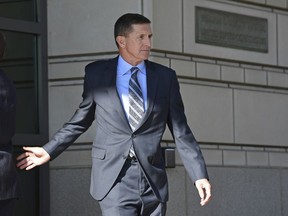 FILE - In this Dec. 1, 2017 file photo, former national security adviser Michael Flynn leaves federal court in Washington. Flynn has been campaigning to support Republican candidates, as he awaits sentencing after pleading guilty to lying to the FBI. In May 2018, Flynn endorsed Montana Republican Senate candidate Troy Downing in a video message, then followed up with a radio interview. In March, he made a personal appearance in California with Republican Omar Navarro in his primary bid for the chance to run against 14-term Democratic U.S. Rep. Maxine Waters.