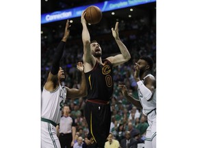 Cleveland Cavaliers center Kevin Love (0) goes up for a shot between Boston Celtics forward Al Horford, left, and guard Jaylen Brown during the first quarter of Game 5 of the NBA basketball Eastern Conference finals Wednesday, May 23, 2018, in Boston.