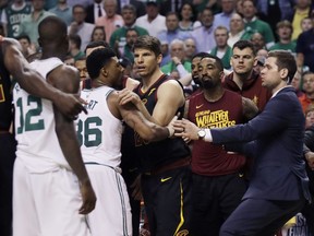 Cleveland Cavaliers and Boston Celtics players hold each other back after shoves between Celtics forward Marcus Morris andCavaliers forward Larry Nance Jr. during the second quarter of Game 5 of the NBA basketball Eastern Conference finals Wednesday, May 23, 2018, in Boston.