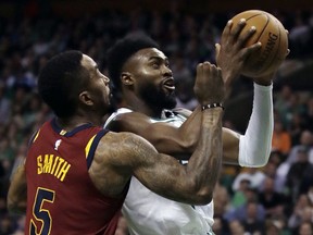 Boston Celtics guard Jaylen Brown, right, tries to drive against Cleveland Cavaliers guard JR Smith (5) during the second half in Game 2 of the NBA basketball Eastern Conference final, Tuesday, May 15, 2018, in Boston.