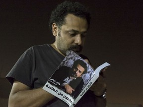 In this June 9, 2017 photo provided by Roger Anis, prominent activist and blogger Wael Abbas signs a copy of his book, "The theory of leaving the bowl," in Cairo, Egypt. Egyptian security officials said Abbas, known for documenting police abuse, was detained, Wednesday, May 22, 2018, the latest in a new wave of arrests since elections earlier this year. The officials said Abbas was held on accusations of disseminating false news and joining an outlawed group, among other charges.