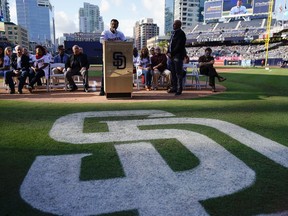 Former San Diego Padres relief pitcher Trevor Hoffman speaks to the crowd with the 1998 National League Championship team to induct former Padres General Manager Kevin Towers into the Padres Hall of Fame, prior to the Padres' baseball game against the St. Louis Cardinals in San Diego, Saturday, May 12, 2018.