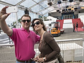 A couple take a selfie photograph in front of the Palais des Festival at the 71st international film festival, Cannes, southern France, Monday, May 7, 2018.