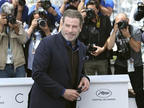 Actor John Travolta poses for photographers during a photo call for the film 'Gotti' at the 71st international film festival, Cannes, southern France, Tuesday, May 15, 2018.