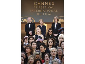 Jury president Cate Blanchett, center top second row, stands as part of 82 film industry professionals on the steps of the Palais des Festivals reading a statement highlighting what they describe as pervasive gender inequality in the film industry, at the 71st international film festival, Cannes, southern France, Saturday, May 12, 2018.