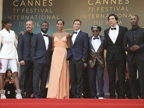 Actors Damaris Lewis, from left, Jasper Paakkonen, John David Washington, Laura Harrier, Topher Grace, director Spike Lee, actors Adam Driver, and Corey Hawkins pose for photographers upon arrival at the premiere of the film 'BlacKkKlansman' at the 71st international film festival, Cannes, southern France, Monday, May 14, 2018.
