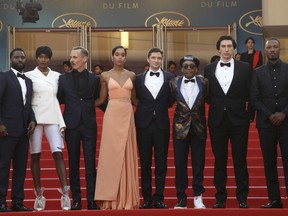 Actors John David Washington, from left, Damaris Lewis, Jasper Paakkonen, Laura Harrier, Topher Grace, director Spike Lee, actors Adam Driver, and Corey Hawkins pose for photographers upon arrival at the premiere of the film 'BlacKkKlansman' at the 71st international film festival, Cannes, southern France, Monday, May 14, 2018.