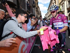 Italian rider Elia Viviani signs autographs prior to the start of the fourth stage of the Giro d'Italia, Tour of Italy cycling race, in Catania, Italy, Tuesday, May 8, 2018.