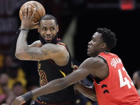 LeBron James of the Cleveland Cavaliers plays keepaway with Toronto Raptors defender Pascal Siakam during Game 4 action in the East Conference semifinal Monday in Cleveland. James had a game-high 29 points as the Cavs posted a 128-93 win to complete a four-game sweep and advance to the Eastern Conference final.
