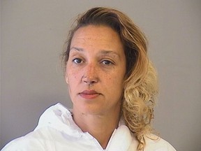 This photo provided by the Tulsa County Sheriff's Office shows Taheerah Ahmad who remains jailed Wednesday, May 16, 2018, after authorities accused her of stabbing one of her daughters and setting their home on fire. Authorities say Ahmad was arrested in downtown Tulsa Tuesday and another daughter who had been reported missing was found safe, police said. (Tulsa County Sheriff's Office via AP)