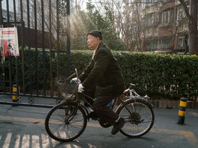 Han Zicheng, 85, rides his bicycle to a nearby market in Tianjin, China, in January.