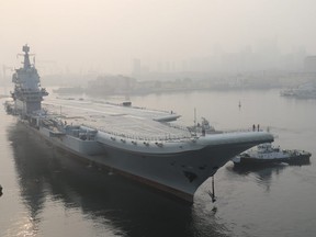 In this May 13, 2018, file photo provided by China's Xinhua News Agency, China's aircraft carrier leaves Dalian in northeast China's Liaoning Province for sea trials.