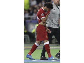 Liverpool's Mohamed Salah reacts after injuring himself during the Champions League Final soccer match between Real Madrid and Liverpool at the Olimpiyskiy Stadium in Kiev, Ukraine, Saturday, May 26, 2018