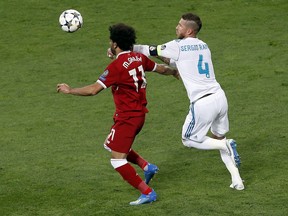 Liverpool's Mohamed Salah, left, and Real Madrid's Sergio Ramos, right, challenge for the ball during the Champions League Final soccer match between Real Madrid and Liverpool at the Olimpiyskiy Stadium in Kiev, Ukraine, Saturday, May 26, 2018.