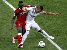 Liverpool's Sadio Mane, left, and Real Madrid's Casemiro, right, challenge for the ball during the Champions League Final soccer match between Real Madrid and Liverpool at the Olimpiyskiy Stadium in Kiev, Ukraine, Saturday, May 26, 2018.