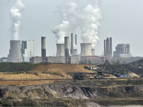 In this April 3, 2014 file photo giant machines dig for brown coal at the open-cast mining Garzweiler in front of a power plant near the city of Grevenbroich in western Germany. Allianz says it will stop insuring coal-fired power plants and coal mines as part of its contribution to combating climate change.  "If you don't have policies that underpin the number that's been put in Paris, you've got nothing to drive progress," said Elina Bardram, a European Commission official who's head of the EU delegation at the talks in Bonn.