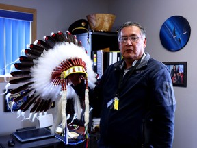Chief Clifford Bull of the Lac Seul First Nation shows his ceremonial headdress in his office in Frenchman's Head, Ont., on Tuesday, April 24, 2018. Bull is running for the Progressive Conservatives in the June 7 provincial election in the new Indigenous-dominated provincial riding of Kiiwetinoong.