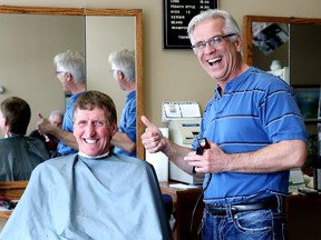 Barber Paul Guindon (right) is seen with client Laurent Isabelle in Kapuskasing, Ont., on Wednesday, April 18, 2018. The town has become the political centre of gravity for the Ontario new riding of Mushkegowuk-James Bay.