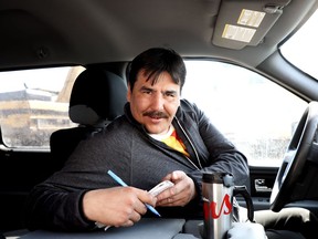 Chief Paul Burke makes notes in his truck in Fort Severn, Ontario's most northerly community, on Saturday, April 28, 2018. Burke's aim is to try to wean his community off federal dollars.