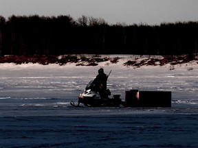 A hunter rides a snowmobile across the frozen Severn River in Fort Severn, Ontario's most northerly community, on Friday, April 27, 2018. Hunting is still very much part of the community's way of life.