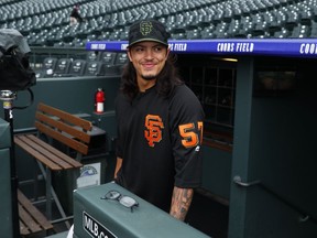 San Francisco Giants pitcher Derek Rodriguez, who was called up from the team's Triple-A team in Sacramento, walks up the dugout stairs and onto the warning track of Coors Field as he warms up before playing in a baseball game against the Colorado Rockies, Monday, May 28, 2018, in Denver.