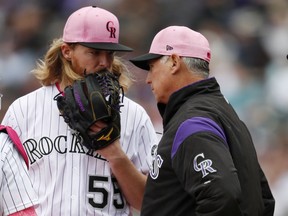 Colorado Rockies starting pitcher Jon Gray, left, confers with manager Bud Black who visits the mound after Gray gave up a single to Milwaukee Brewers' Jonathan Villar in the third inning of a baseball game Sunday, May 13, 2018, in Denver.