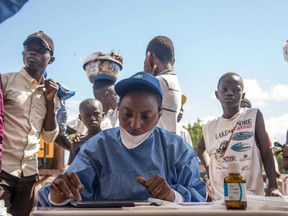 Nurses working with the World Health Organization (WHO) prepare to administer vaccines at the town all of Mbandaka on May 21, 2018 during the launch of the Ebola vaccination campaign. The death toll in an outbreak of Ebola in the Democratic Republic of Congo (DRC) rose to 26 on May 21, 2018, after a person died in the northwest city of Mbandaka, the government said, as it began vaccinating first responders against the dreaded disease.