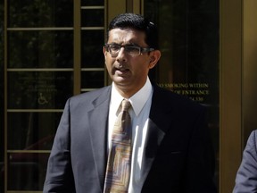 Dinesh D'Souza leaving federal court, in New York, Tuesday, May 20, 2014. D'Souza has pleaded guilty in New York federal court to making illegal campaign contributions.