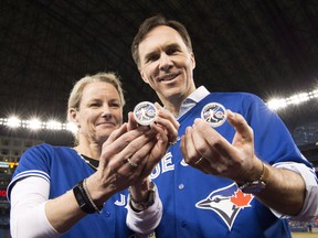 Canadian Finance Minister Bill Morneau and Sandra Hanington, president and CEO of the Royal Canadian Mint, unveil a silver collector coin celebrating the 40th season of the Toronto Blue Jays before the Blue Jays play the Oakland Athletics in AL baseball action in Toronto on Friday April 22, 2016. Hanington tendered her resignation this week, citing a wish to find better work-life balance.