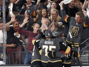 In this Friday, May 18, 2018, file photo, Vegas Golden Knights left wing Tomas Nosek, left, celebrates with teammates after scoring against the Winnipeg Jets during the second period of Game 4 of the NHL hockey Western Conference finals in Las Vegas. A warm getaway destination that offers live winter sports, Las Vegas now fits that bill for Western Canadians. Sin City's desert climate combined with a new NHL team currently in the Stanley Cup final and regular world curling events just a short flight away are increasing traffic from Canada's most western provinces.