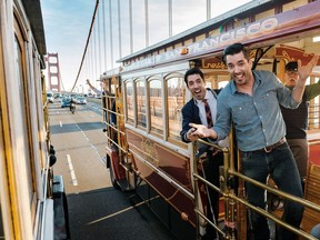 Drew, left, and twin brother Jonathan Scott pose for a photo riding along the Golden Gate Bridge in San Francisco, Calif., in an undated handout image. The new episodes of "Brother vs. Brother" challenge the siblings to buy, renovate and flip homes in one of the most expensive housing markets in North America - San Francisco. The idea is to see who can gain the highest increase on both price and value, with money being raised for charity.