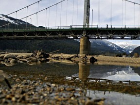 A man crosses a bridge over the Columbia River in Revelstoke, B.C., on March 14, 2010. Canadian negotiators are resisting American attempts to increase the amount of water released into the Columbia River, a major waterway in British Columbia and the Pacific Northwest. The issue was part of this week's opening talks in the modernization of the treaty that governs how the two countries manage the river.