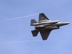 In this Wednesday, Sept. 2, 2015, file photo, an F-35 jet arrives at its new operational base at Hill Air Force Base, in northern Utah. Canada has quietly paid another $54 million toward development of the F-35 stealth fighter, bringing its total investment in the controversial project over the past 20 years to roughly half a billion dollars.
