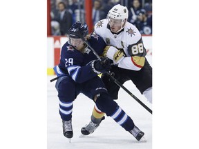 Vegas Golden Knights' Nate Schmidt (88) and Winnipeg Jets' Patrik Laine (29) collide during second period NHL action in Winnipeg on Thursday, February 1, 2018.