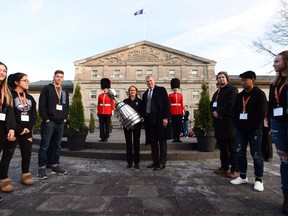 Governor General Julie Payette and CFL commissioner Randy Ambrosie welcome the Grey Cup as it arrives at Rideau Hall in Ottawa on Tuesday, Nov. 21, 2017., as youth from Encounters With Canada look on.