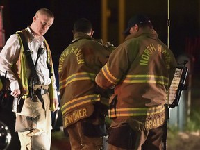 Emergency personnel respond to Quinnipiac Avenue in North Haven, Conn., at the scene of explosion and reported stand-off Wednesday evening, May 2, 2018. A barn behind a house in Connecticut exploded Wednesday night while police and a SWAT team were negotiating with a man who had taken his wife and family hostage, leaving several officers injured, officials said.