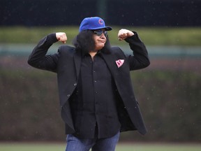 KISS's Gene Simmons reacts after throwing the ceremonial first pitch before a baseball game between the Chicago Cubs and the Chicago White Sox, in Chicago, on Friday, May 11, 2018.