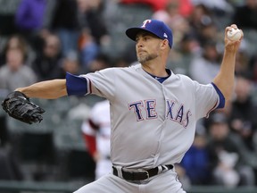 Texas Rangers starting pitcher Mike Minor throws against the Chicago White Sox during the first inning of a baseball game Sunday, May 20, 2018, in Chicago.