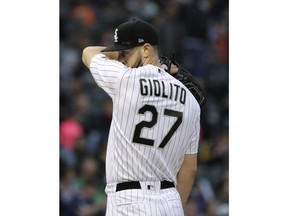 Chicago White Sox starting pitcher Lucas Giolito wipes his face during the third inning of a baseball game against the Texas Rangers, Saturday, May 19, 2018, in Chicago.