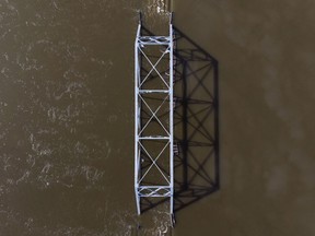 A steel bridge is engulfed by the rising floodwater from the Saint John River in Lakeville Corner, N.B. on Wednesday, May 2, 2018.