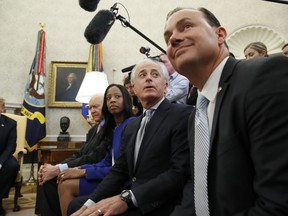 President Donald Trump, left, sits with Sen. Orrin Hatch, R-Utah, Rep. Mia Love, R-Utah, Sen. Bob Corker, R-Tenn., and Sen. Mike Lee, R-Utah, as they meet with Joshua Holt, who was recently released from a prison in Venezuela, in the Oval Office of the White House, Saturday, May 26, 2018, in Washington.