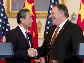 Secretary of State Mike Pompeo and Chinese State Councilor and Foreign Minister Wang Yi shake hands following a news conference at the State Department, Wednesday, May 23, 2018, in Washington.