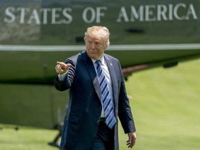 President Donald Trump points to members of the media as he arrives on the South Lawn of the White House in Washington, Friday, May 25, 2018, after attending a graduation and commissioning ceremony at the U.S. Naval Academy in Annapolis, Md.