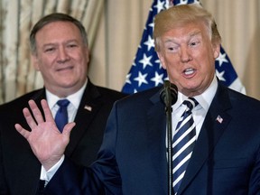 President Donald Trump, accompanied by Secretary of State Mike Pompeo, speaks during a ceremonial swearing in for Pompeo at the State Department, Wednesday, May 2, 2018, in Washington.