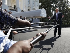 President Donald Trump speaks to the media as he walks to the Marine One helicopter Friday, May 25, 2018, on the South Lawn of the White House in Washington.  Trump is traveling to Annapolis, Md., to address the U.S. Naval Academy graduation ceremonies.