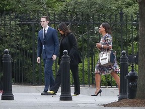 Kim Kardashian, center, arrives at the security entrance of the White House in Washington, Wednesday, May 30, 2018.