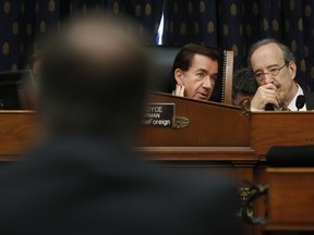 Chairman Rep. Ed Royce, R-Calif., center, talks with Ranking Member Rep.Eliot Engel, D-NY., right, as they listen to testimony by Secretary of State Mike Pompeo, left, at the House Foreign Affairs Committee hearing on Capitol Hill in Washington, Wednesday, May 23, 2018.