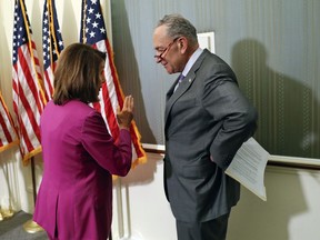 Sen. Chuck Schumer, D-NY., right, and House Minority Leader Nancy Pelosi of Calif., left, talk to one another after hosting a news conference to announce a proposed increase to teacher pay, on Capitol Hill in Washington, Tuesday, May 22, 2018.